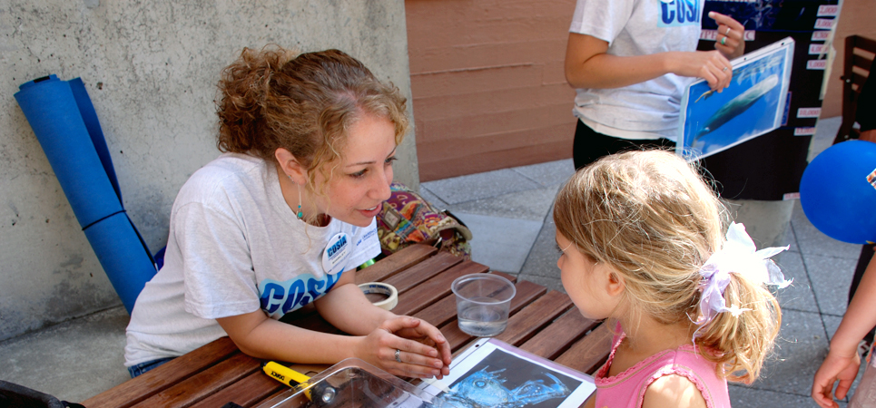 A woman asks a young girl about her knowledge of the deep ocean as part of an informal learning activity