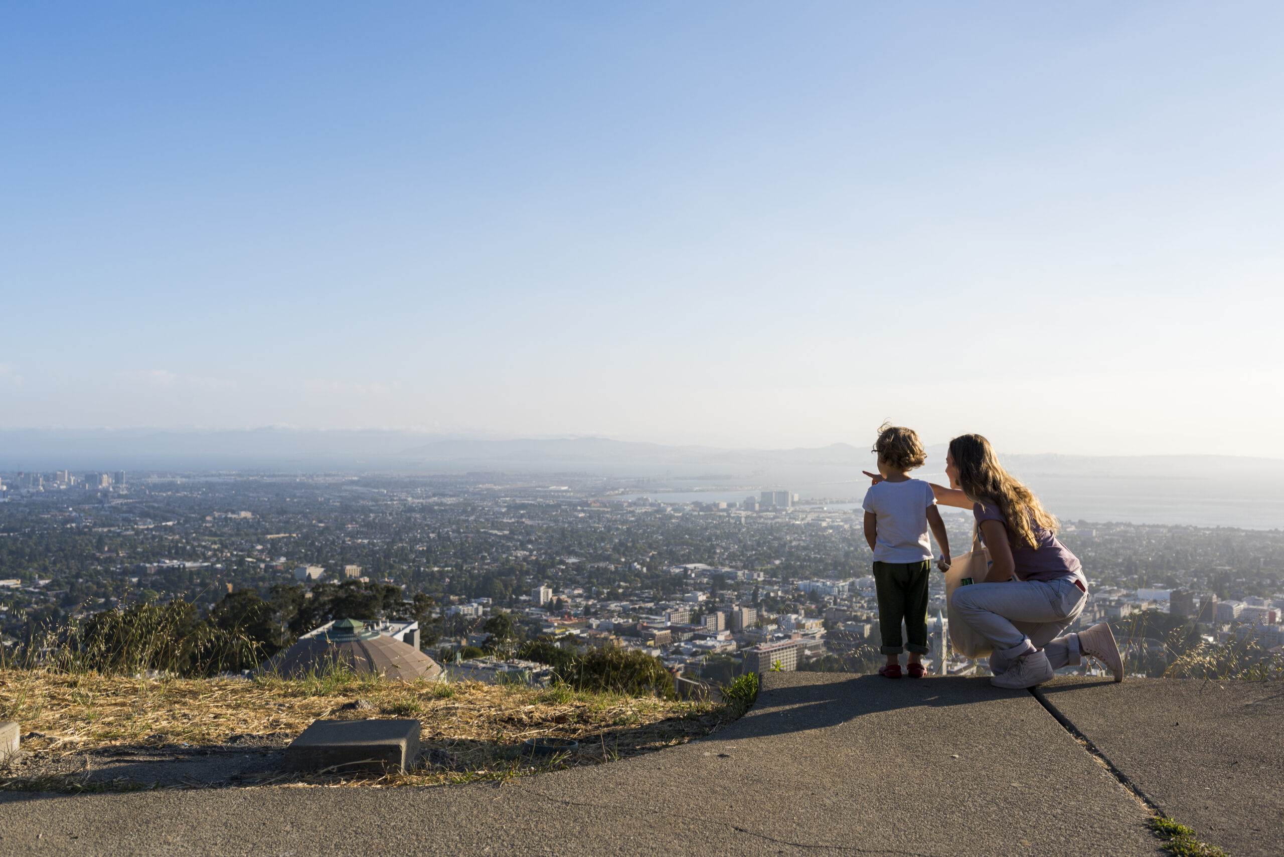 A Mother and child look out over The Lawrence's panoramic view of the San Francisco Bay.