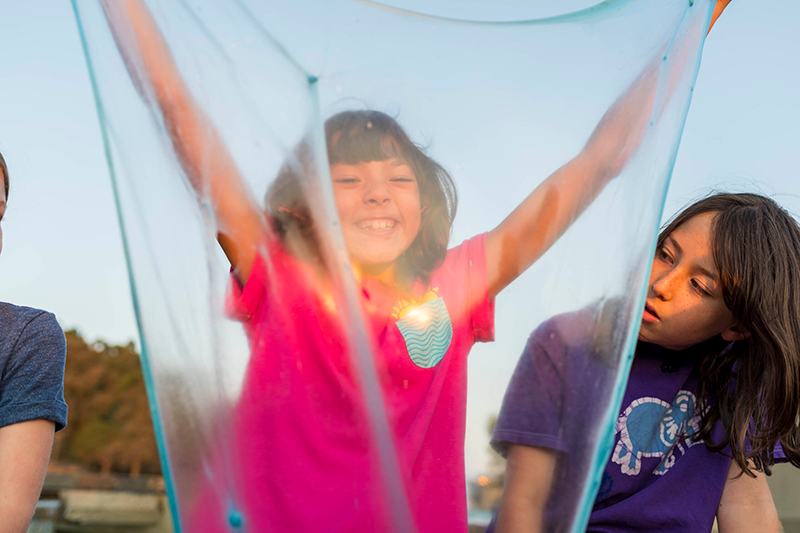 A student holds up her slime during a slime engineering activity